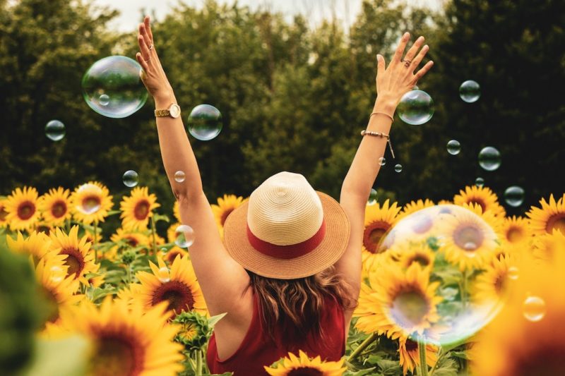 woman-surrounded-by-sunflowers_